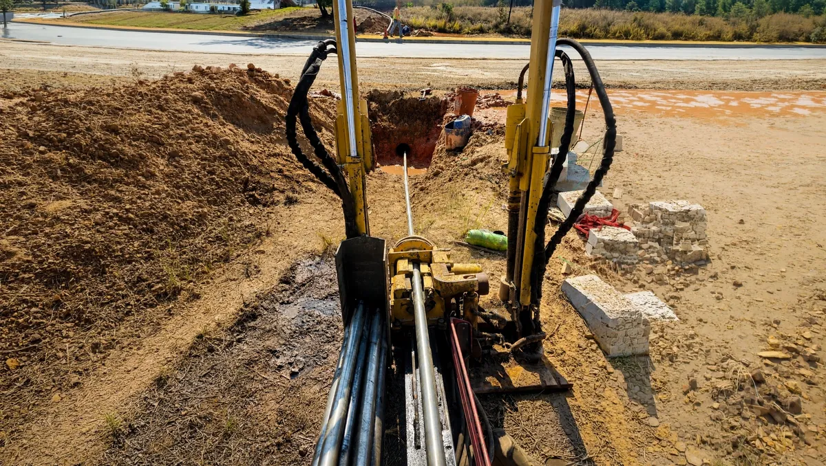 Directional drilling rig boring beneath a road