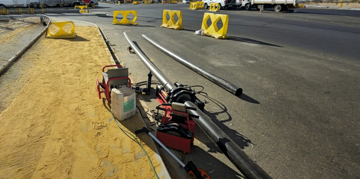 HDPE pipe string laid out at an intersection
